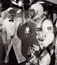 John Young carrying the pair of joke pliers presented by Gunther Wendt prior to the Gemini X launch